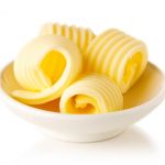 Bowl of butter curls isolated on white background