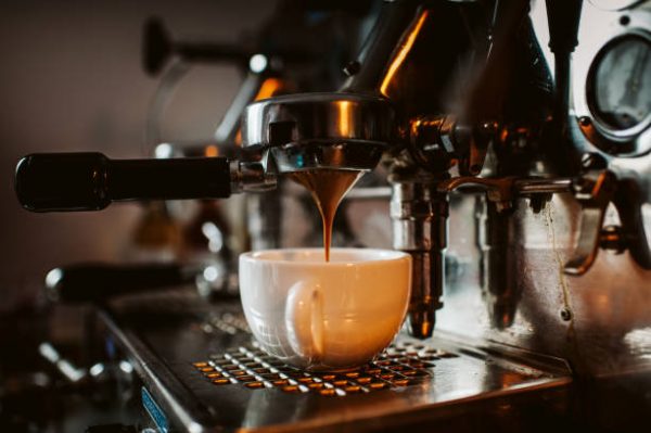 espresso machine pouring coffee into cups